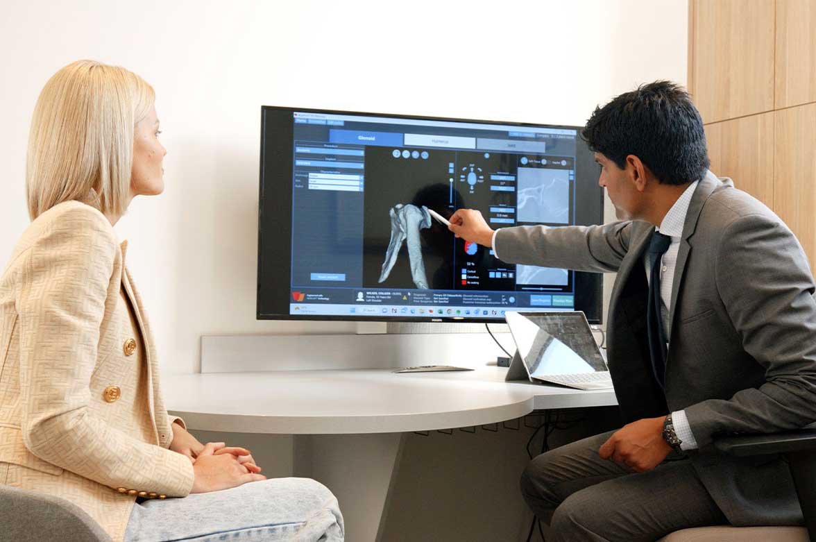 Dr Dan reviewing a shoulder X-Ray with his patient